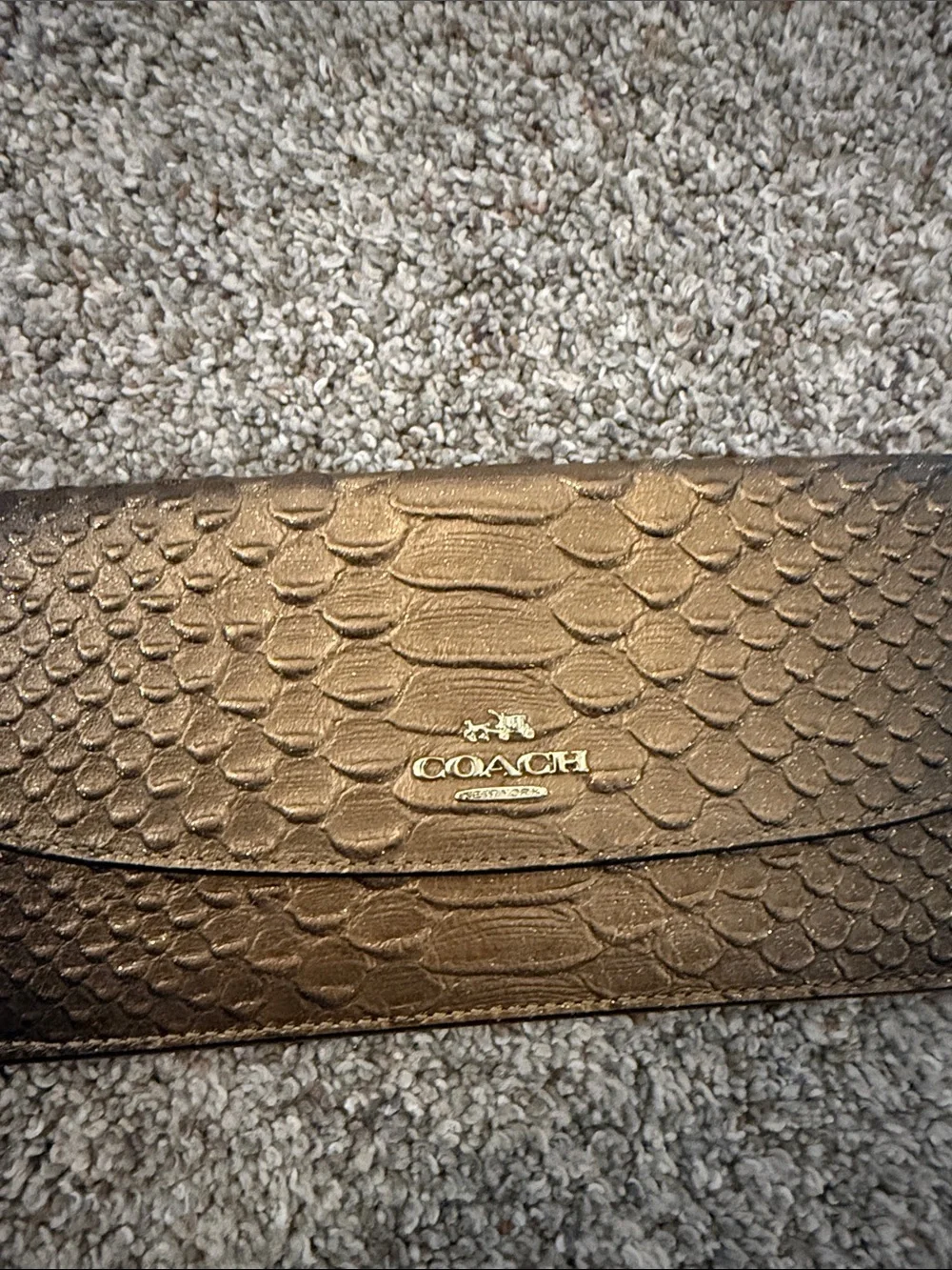 Coach Metallic snake-embossed leather envelope wallet in a muted gold tone